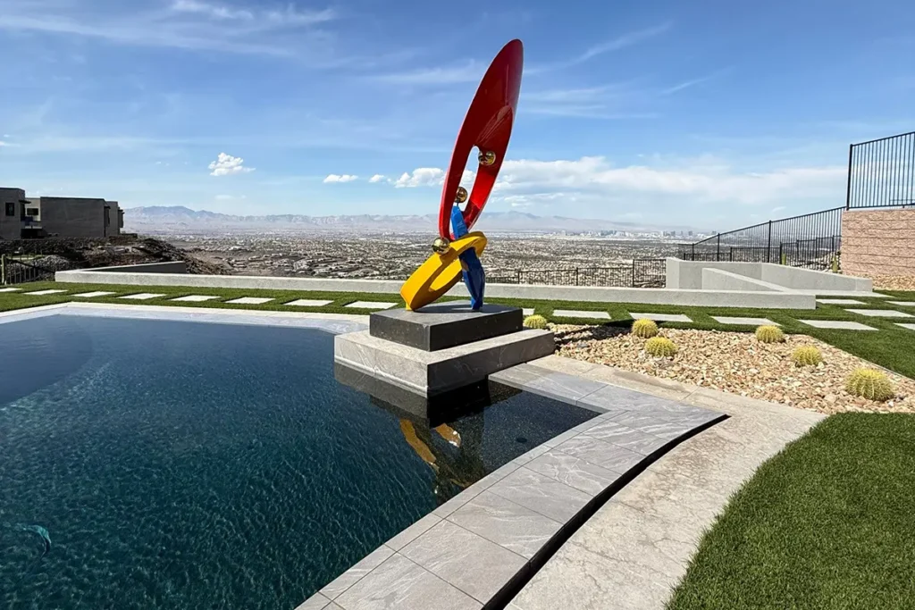 Pool with decorative sculpture overlooking landscape